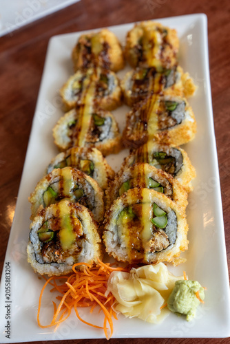 Fried tempura sushi rolls on a white plate