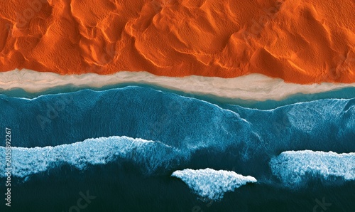 Abstract aerial view of textured orange dunes meeting a turquoise beach and deep blue ocean