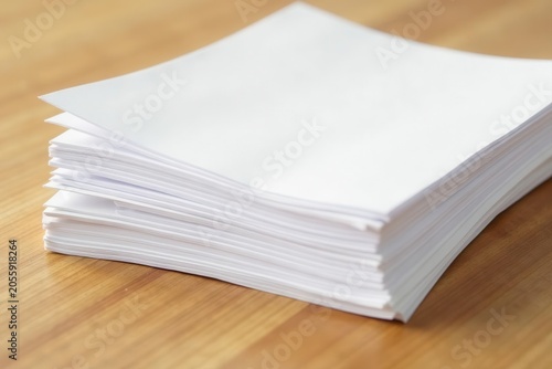 Clean white paper sheets stacked on light brown wood , print, white, modern
