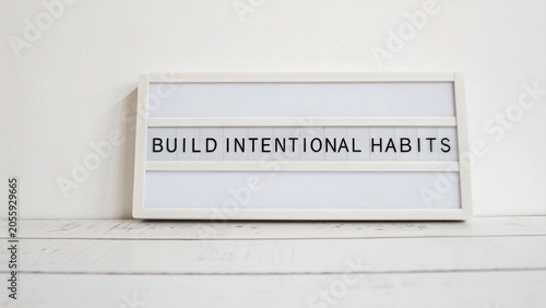 Inspirational sign encouraging personal growth, focus on building intentional habits for self-improvement and daily motivation