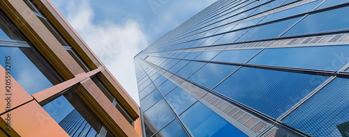 Impressive wide low angle panoramic illustration view looking up at a modern glass skyscraper and colorful building facade in Vienna Austria