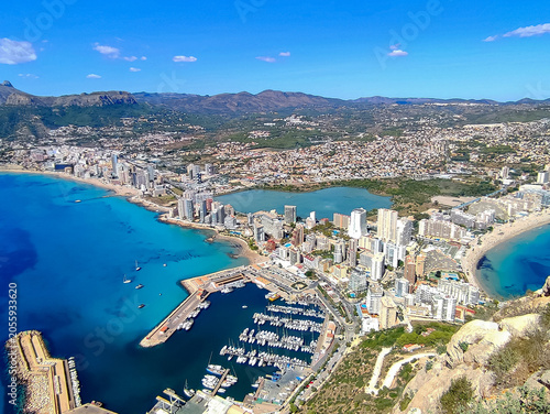 Aerial panoramic high angle view of Calpe city skyline from Penon de Ifach rock with harbor marina lake and sand beaches