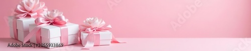 Elegant white gift boxes with pink satin bows and silver accents Pink background , confetti, festive