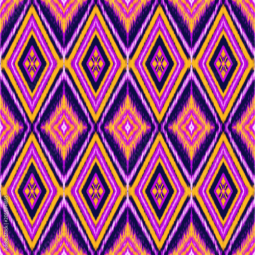 Abstract colourful purple mauve on ethnic ikat on diamonds geometric seamless pattern wallpaper textiles, background. Tribal print design art.