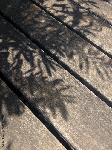 Shadow of leaves on old wooden floor