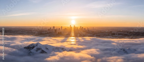 Cityscape with mountains and clouds at sunrise