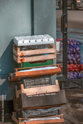 Used containers at the kiosk of a street vendor of vegetables on a summer day