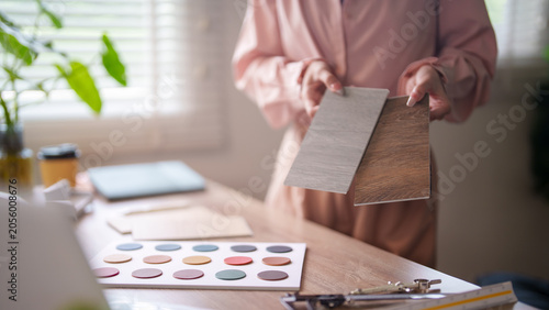 Bild auf Leinwand Interior designer comparing wood and laminate material samples for furniture pro