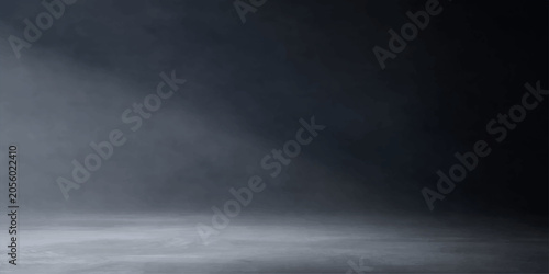 Foto A dark and atmospheric scene illuminated by a single ray of light, casting a spotlight on a misty, smoky floor, evoking a sense of mystery and drama