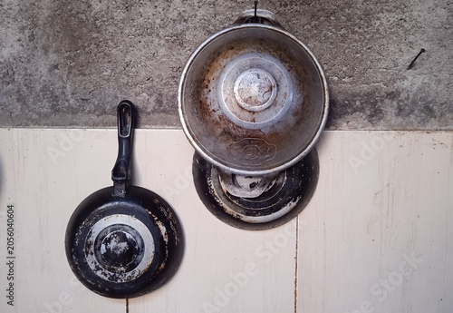 cooking pots hung on a kitchen wall