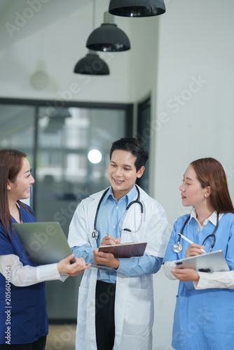 Team of Professional Asian Doctors and Medical Staff Collaborating in Hospital Office