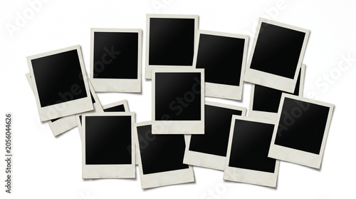 A collection of blank Polaroid photos scattered on a surface