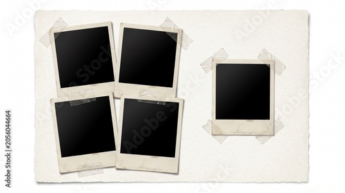 A collection of blank polaroid photos taped on a white surface
