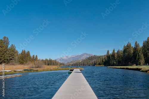 Hume Lake Dock with Snowy Mountain View and Small Boat Sierra Nevada California