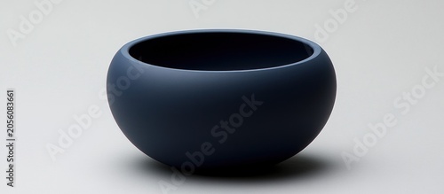 Dark blue bowl on white background, studio shot, minimalist design, home decor