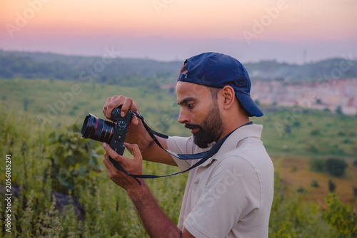 Photography Man with camera photographing scenic landscape at sunset, Banswara, Udaipur, Raj
