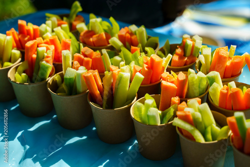 Fotografie Healthy vegetable snacks in individual paper cups for kids' outdoor party picnic
