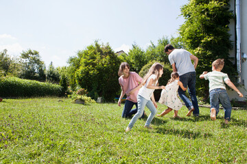 Playful family of five in garden