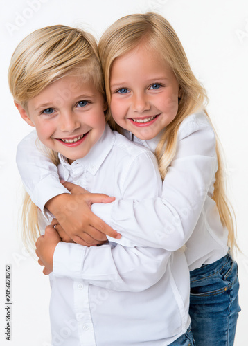 two children on a plain white background hugging and having fun.