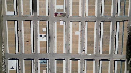 Drone Rising Over Industrial Warehouse Complex in Top Down View