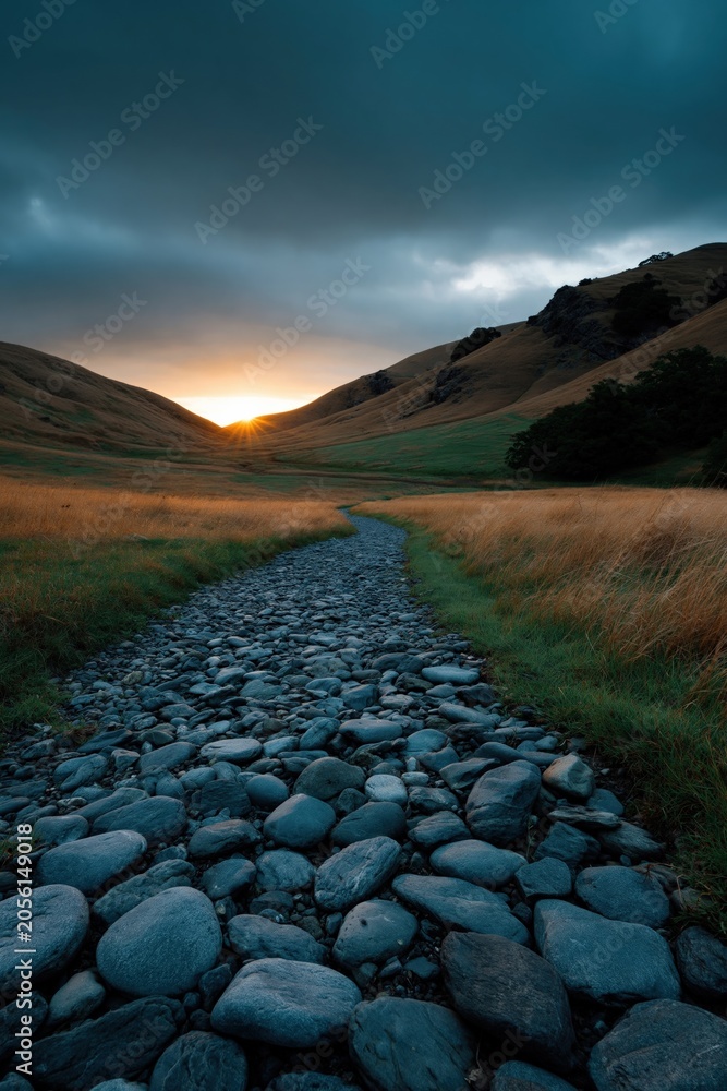 Fototapeta premium Stone path stretching toward glowing sun in narrow valley