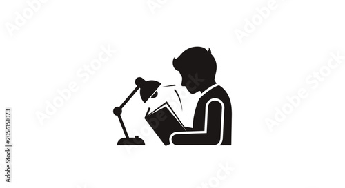 Person reading a book with lamp.
