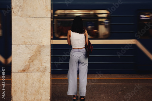 Woman in Moscow Metro Waits for Train to Arrive at the Station