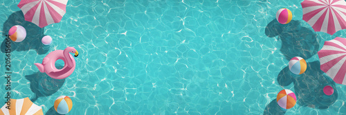 Top view of a swimming pool header with copy space, pink pastel inflatable floatings toys and parasols, summer panoramic background and web banner