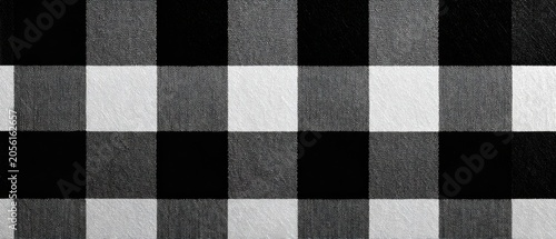 Large scale black and white check squares on woven fabric surface