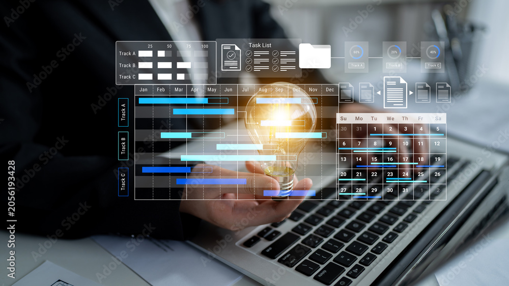 Fototapeta premium Business professional showcases a light bulb symbolizing innovation against a digital project management dashboard on a laptop, highlighting productivity and organization. Gantry
