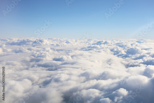 Fotografie Fluffy white clouds seen from above.
