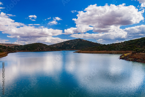 Scenic Lake Reservoir Under Bright Summer Clouds
