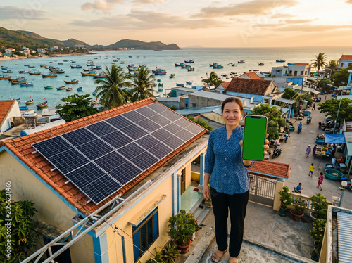 Woman standing on rooftop with solar panels overlooking serene coastal town at sunset.