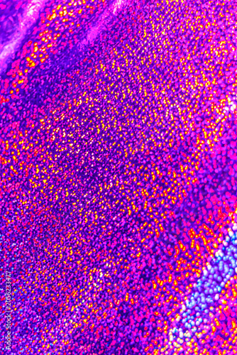 Foto Shimmering purple texture with glimmering dots in various colors on a surface