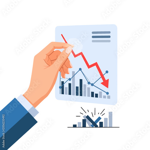 A hand holds a document showing a sharp decline in financial performance metrics
