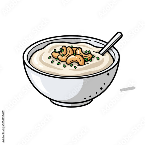 A white bowl filled with creamy soup topped with nuts and herbs
