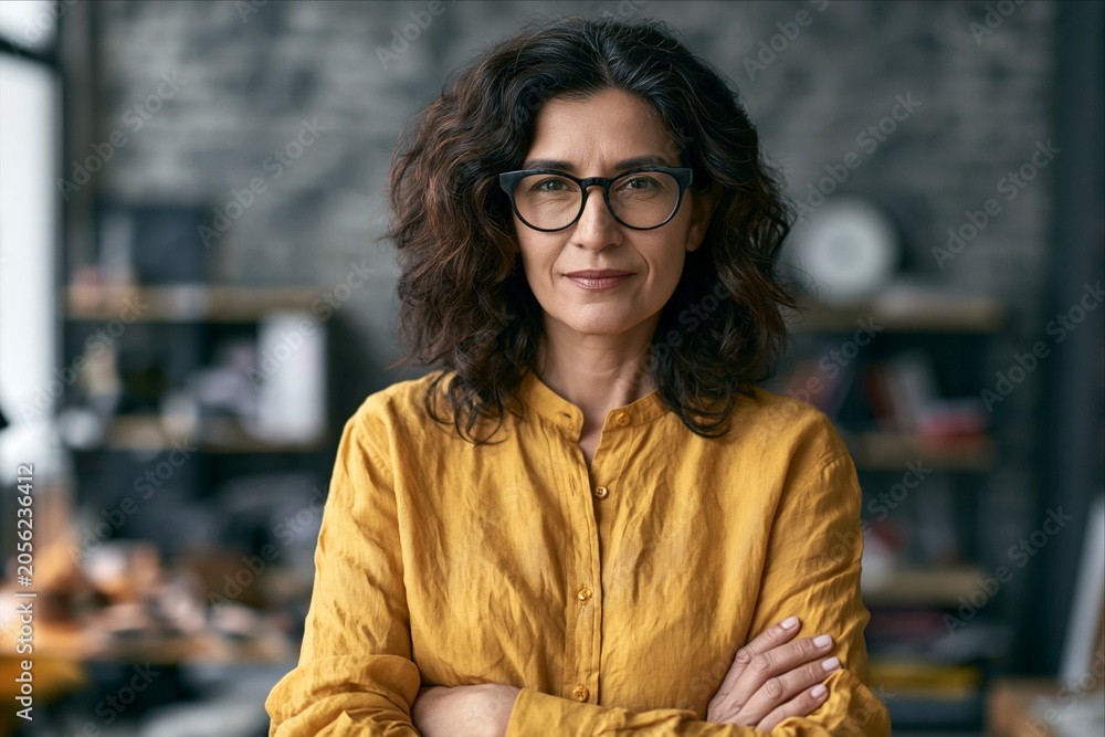 Fototapeta premium Experienced Latina business owner looking at camera in creative office