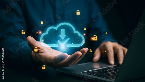 Secure cloud data storage and download icon held in hand with a laptop in the background