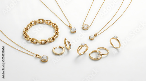 Gold jewelry with diamonds on white background, featuring necklaces and rings