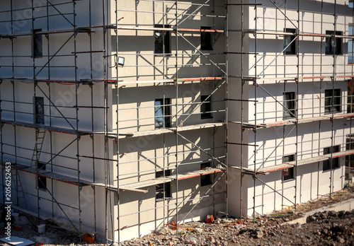 Εκτύπωση καμβά Modern residential building facade covered in metal scaffolding during construction work