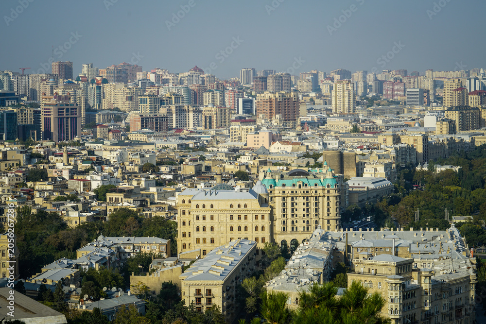 Obraz premium Baku Cityscape with Museum Center, Historic Buildings, and Modern Rooftops under Clear Skies, Azerbaijan.