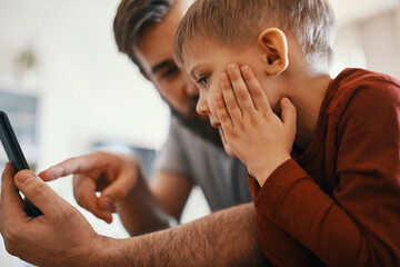 Father and little son with smartphone