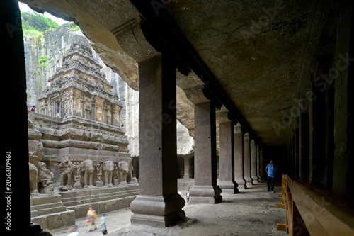 View of Kailash temple through intricately carved corridor with stone pillars supporting the rock ceiling. Cave # 16, Ellora caves, UNESCO World Heritage Site, Maharashtra, India,