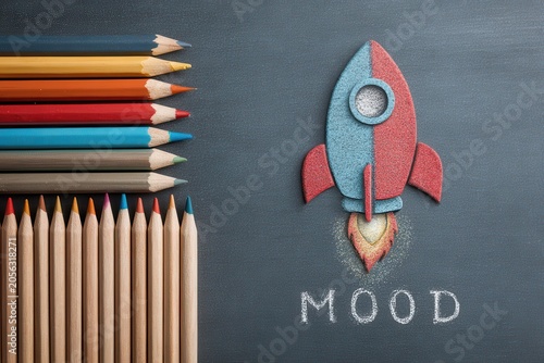Creative rocket launch on chalkboard with colorful pencils, representing back to school learning and imagination