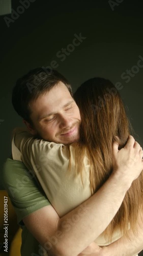 Happy loving couple embracing each other, showing tenderness and affection in warm and intimate moment. Content man hugging his beloved woman in secure embrace. Romantic couple embracing tenderly