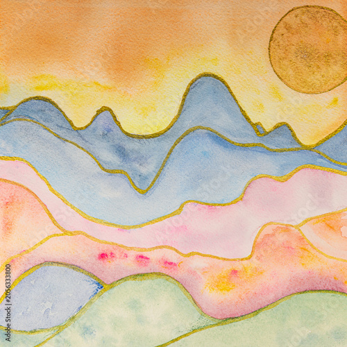 Abstract painting of golden sun on bright colorful mountains. The dabbing technique gives a soft focus effect due to the altered surface roughness of the paper.