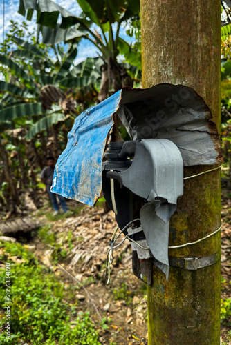 Bilde på lerret Improvised makeshift plastic cover protecting an outdoor electric switch on a ut