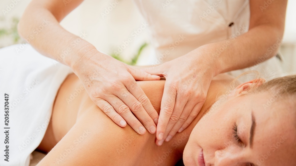 Fototapeta premium Person receiving a relaxing back massage in a spa setting.
