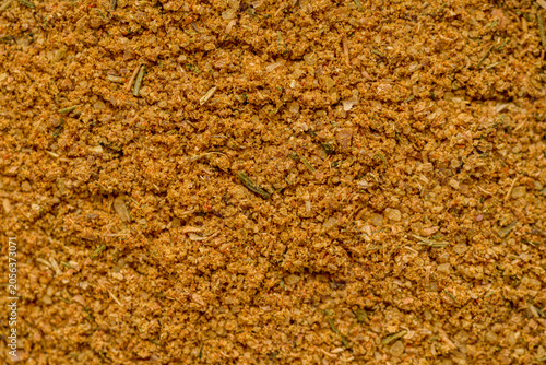 Obraz na plátně Closeup Jamaican jerk seasoning texture, warm orangebrown grains with dried herb