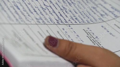 Close up shot of notebook page turning with handwritten notes and paper texture.